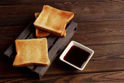 Toasts with jam on dark wooden table