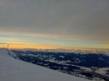 Scenic view of snow covered mountains against sky during sunset