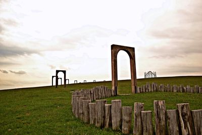 Gate on landscape against sky