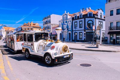 Cars on road against buildings in city