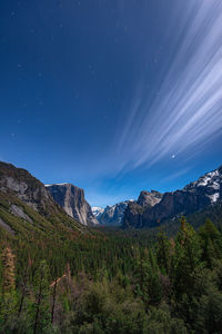 Scenic view of mountains against blue sky at night