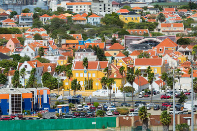 High angle view of houses by buildings in town