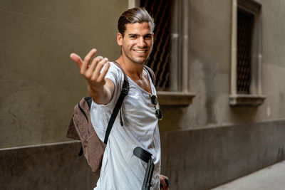 Young latin man with crutches visiting the city