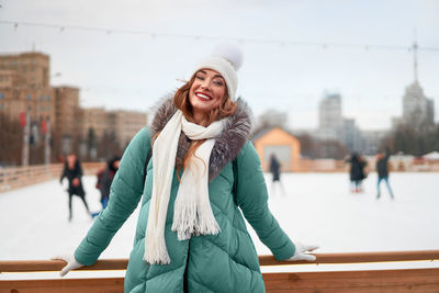 Portrait of smiling woman standing outdoors during winter