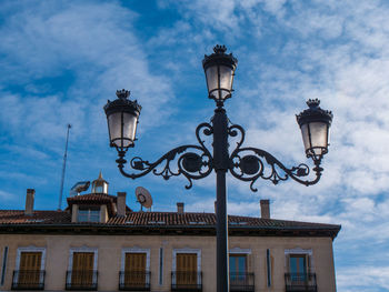 Low angle view of street light against building