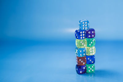 Close-up of dices over blue background