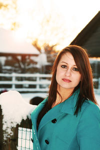 Portrait of beautiful woman standing in snow