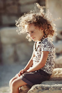 Cute girl sitting outdoors