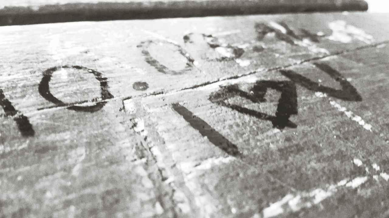 street, high angle view, road, asphalt, text, transportation, snow, road marking, guidance, winter, communication, western script, cold temperature, bicycle, weather, shadow, road sign, day, outdoors, close-up