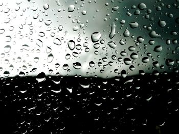 Close-up of water drops on white surface