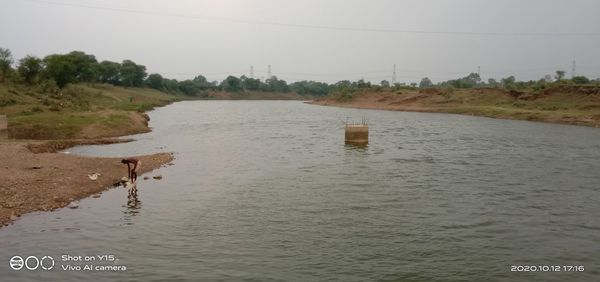 Scenic view of river against clear sky