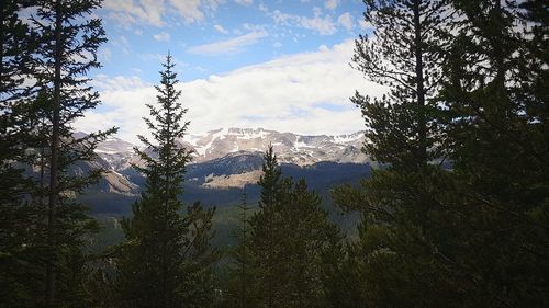 Scenic view of mountains against cloudy sky