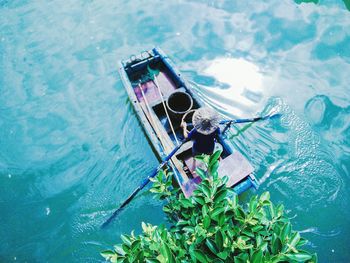 High angle view of person oaring boat in lake