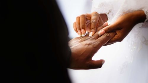 Midsection of couple holding hands