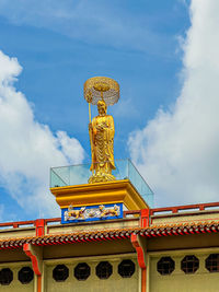 Low angle view of statue against sky
