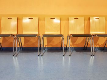 Empty chairs and tables in building