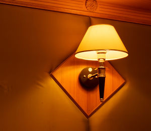 Close-up of illuminated lamp on table at home