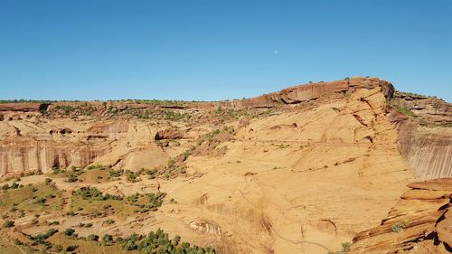 Scenic view of rock formations against blue sky