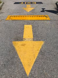 High angle view of arrow sign on road