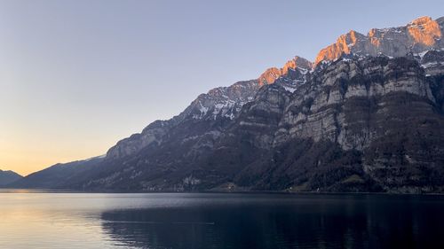 Scenic view of sea and mountains against sky