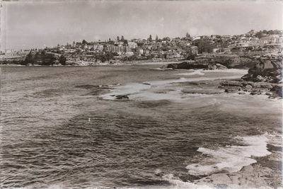 Scenic view of sea and buildings against sky