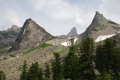 Scenic view of mountains against cloudy sky