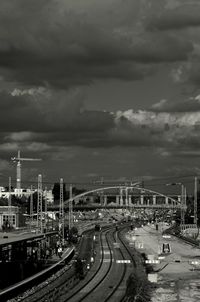 Cars on road against cloudy sky