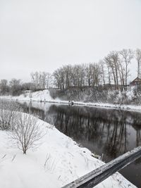 Scenic view of frozen lake against sky during winter