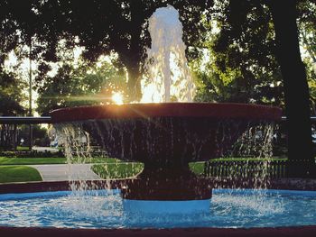 Water fountain in swimming pool against sky