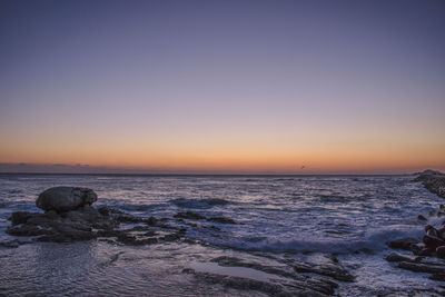 Scenic view of sea against clear sky during sunset