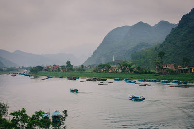 Scenic view of lake and mountains against sky