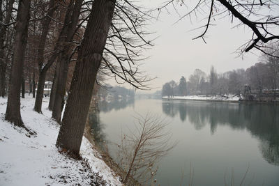 Scenic view of lake against sky during winter