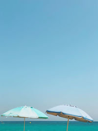 Umbrellas in front of the sea in summer, blank space on top