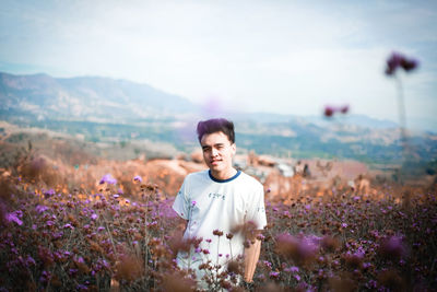 Portrait of man on field against sky