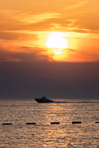 Scenic view of sea against orange sky during sunset