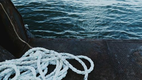 High angle view of rope tied on pier