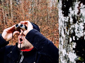 Man looking through binoculars