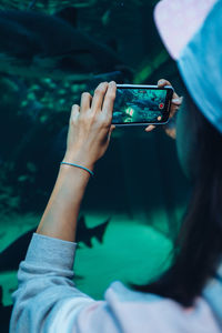 Midsection of man using mobile phone