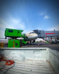 Airplane on runway against sky