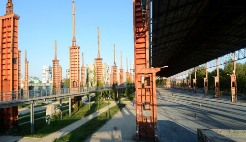 Bridge over canal by buildings in city against sky