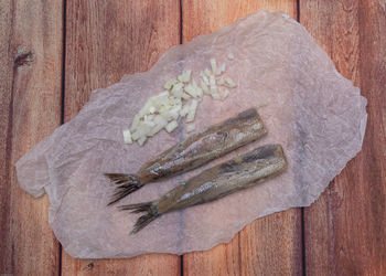 High angle view of fish on cutting board