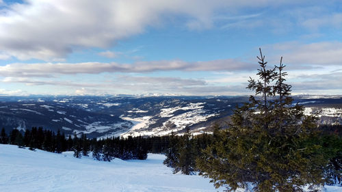 Scenic view of snow covered mountains against sky