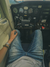 Low section of person sitting in airplane