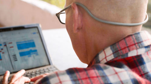 Midsection of man using mobile phone