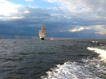 Ship sailing in sea against sky