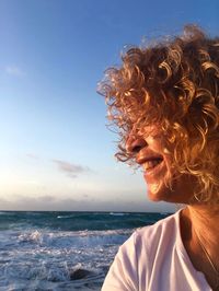 Close-up of woman at beach against sky