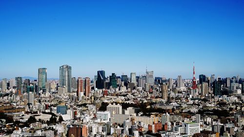Aerial view of modern buildings against blue sky