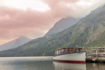 Scenic view of river and mountains against sky