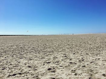 Scenic view of desert against clear blue sky