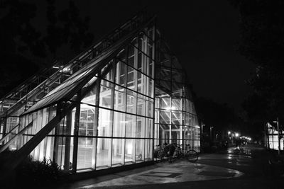 Low angle view of illuminated building against sky at night